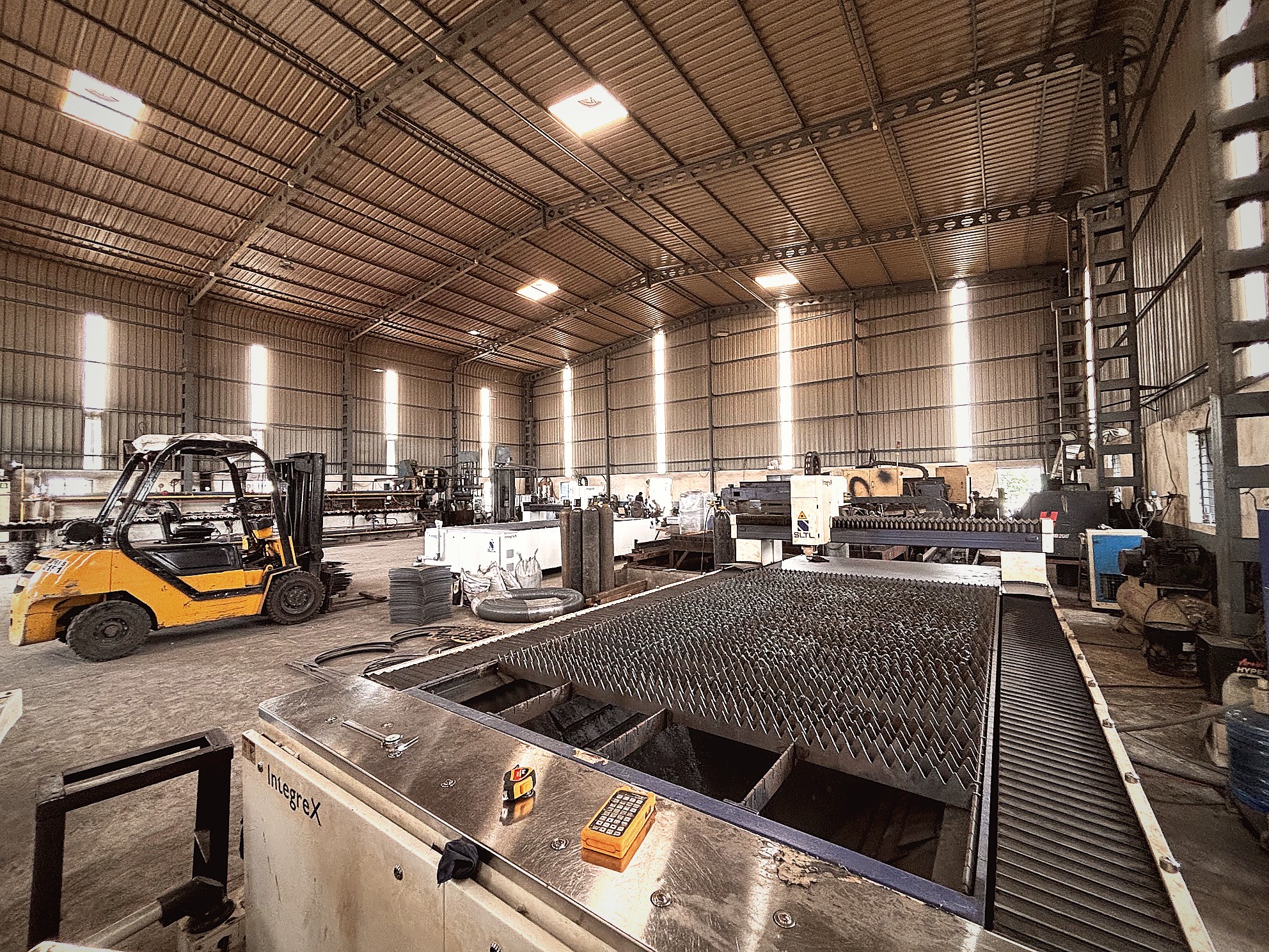 Factory floor overview with CNC laser and forklift