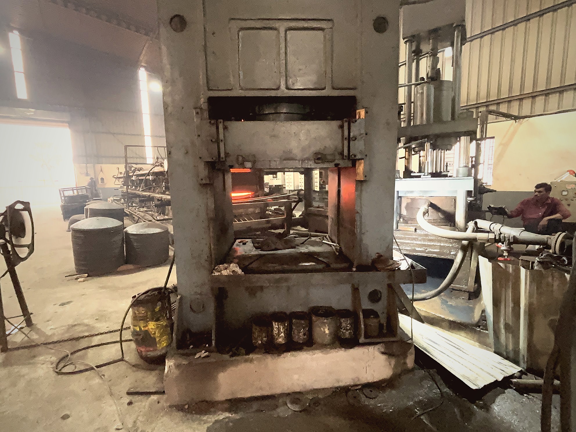 Press quench machine with furnace in background